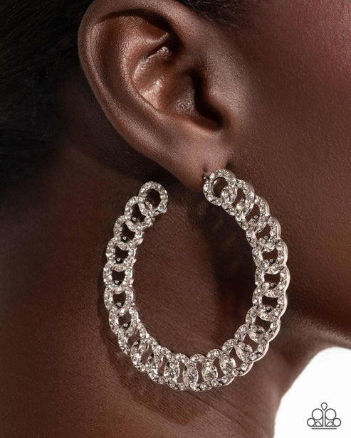 Silver hoop earring worn by a model