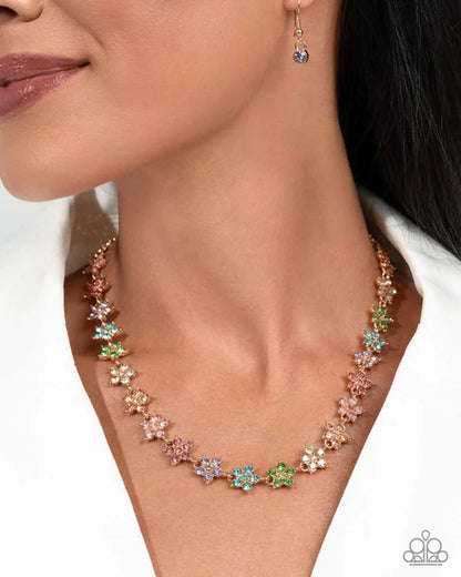 Multicolored floral necklace worn by a model on a white background