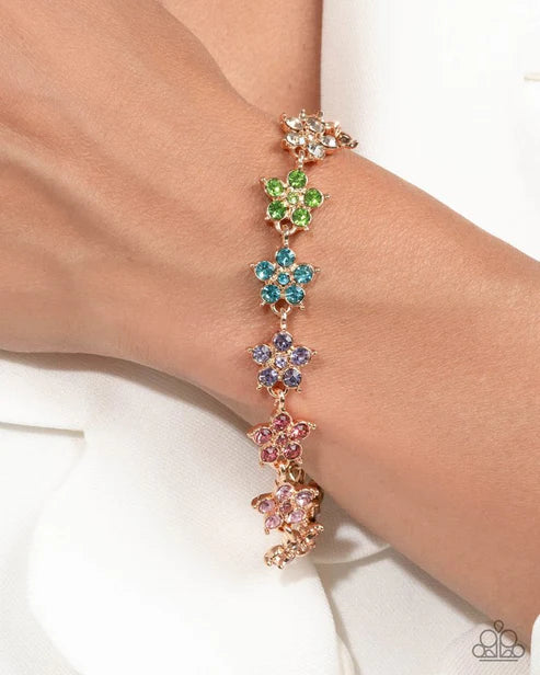 Multicolored floral bracelet on a wrist with a white background