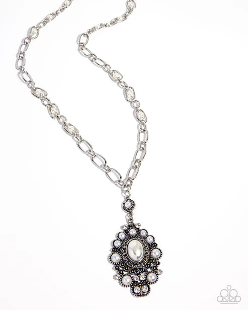 Silver necklace with a decorative pendant on a white background