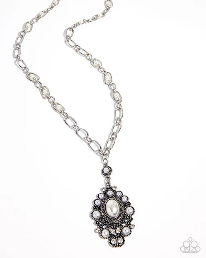 Silver necklace with a decorative pendant on a white background