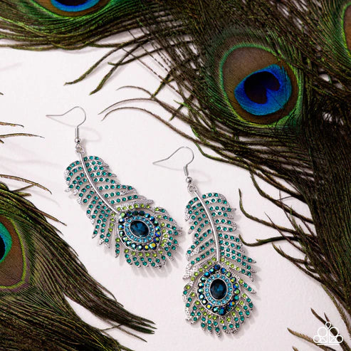 Decorative earrings with peacock feathers on a white background
