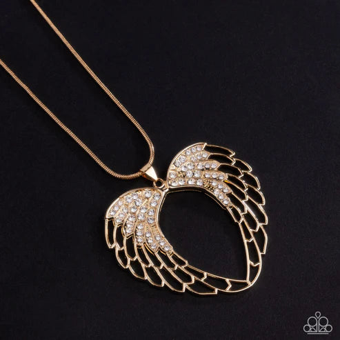 Gold wing-shaped pendant necklace on a black background