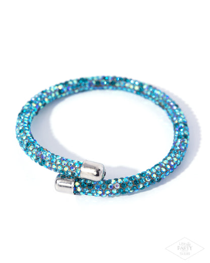 Blue beaded bracelet with a silver clasp on a white background