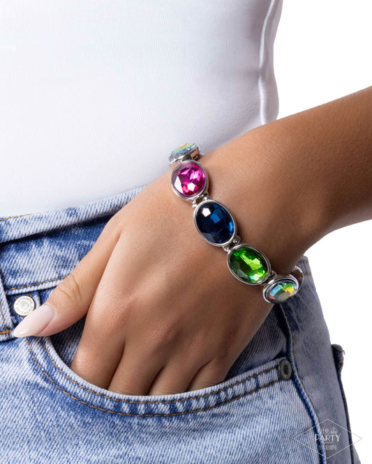 Multicolored beaded bracelet on a wrist with a denim jacket background
