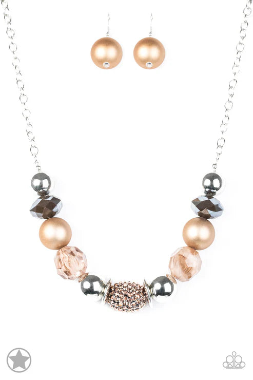 Necklace with pink and rose gold beads on a white background