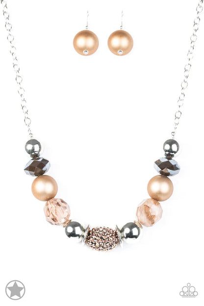 Necklace with pink and rose gold beads on a white background