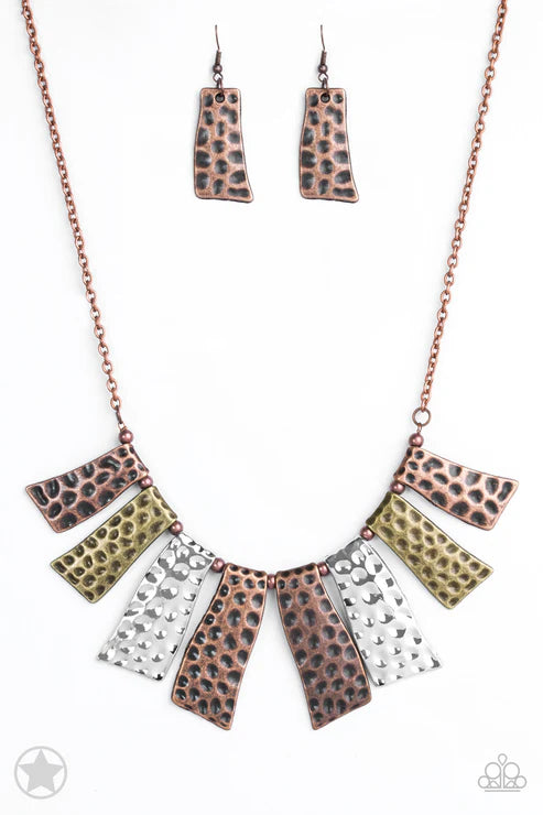 Necklace and earrings set with leopard print and metallic accents on a white background