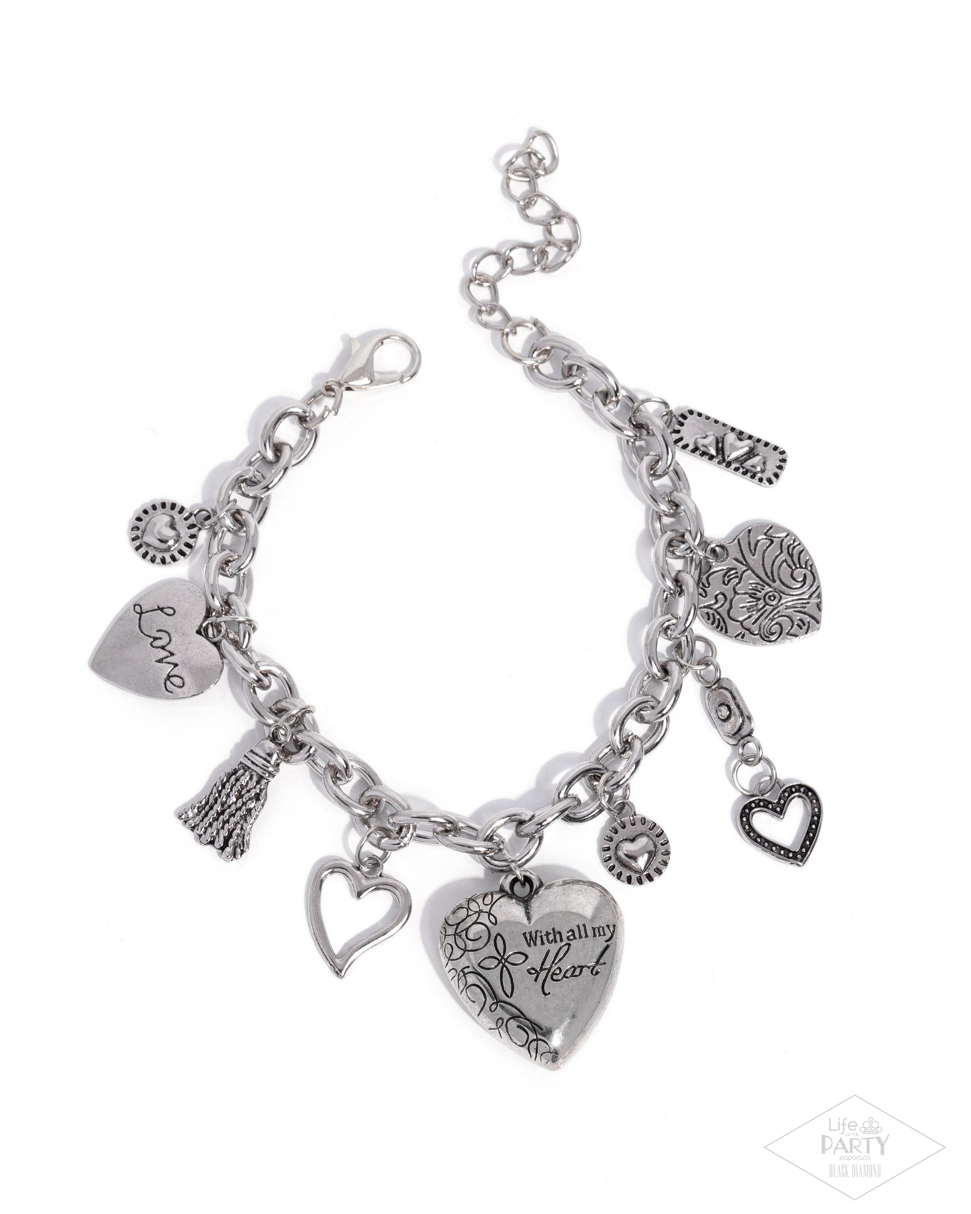Silver charm bracelet with various charms on a white background