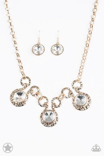 Jewelry set with necklace and earrings featuring rose gold and clear gemstones on a white background.