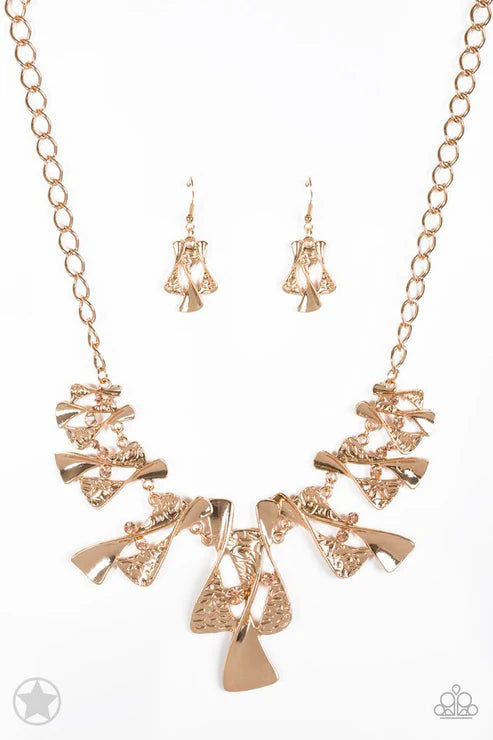 Rose gold necklace and earrings set on a white background