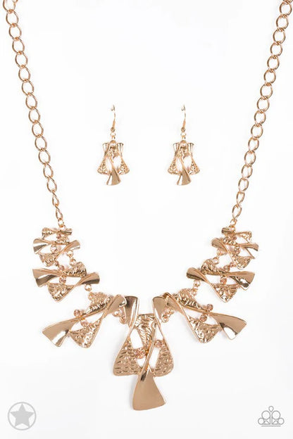 Rose gold necklace and earrings set on a white background