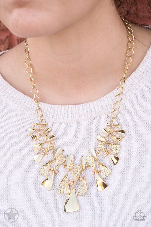 Gold necklace with leaf-like pendants on a white background
