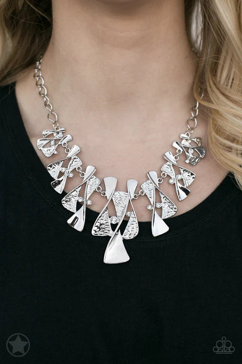 Silver necklace with geometric pendants on a black background