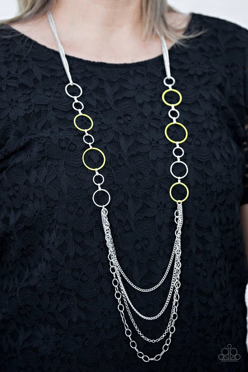 Long necklace with circular links on a black lace top