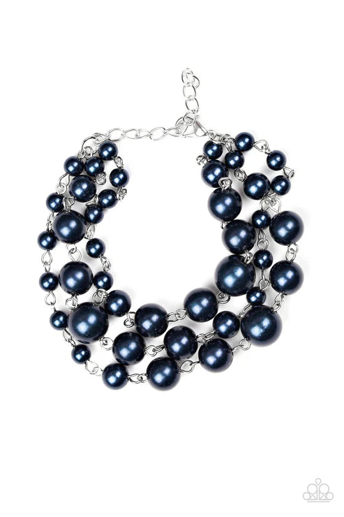Multi-layered black pearl necklace on a white background