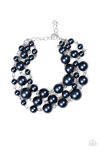 Multi-layered black pearl necklace on a white background