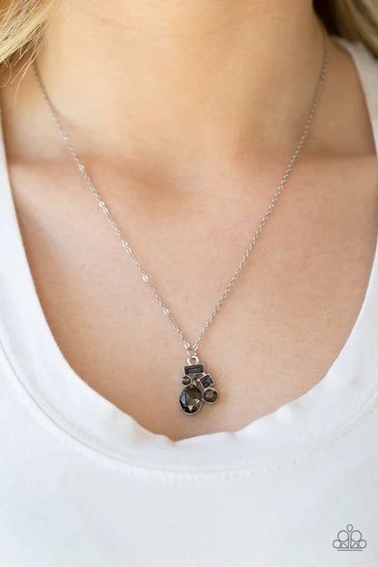 Silver necklace with a pendant worn by a person on a white background