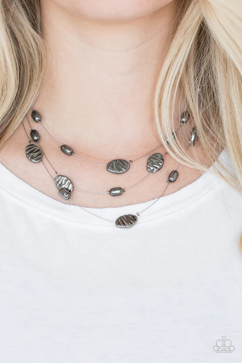Silver necklace with pendant on a white background