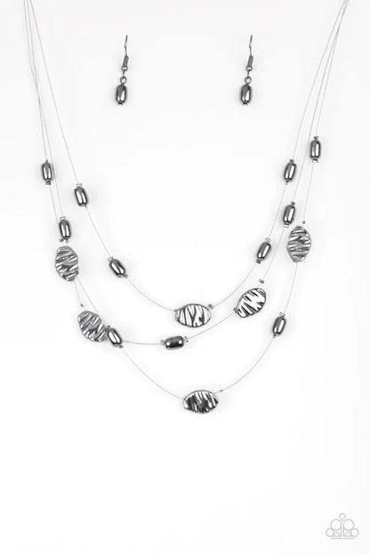 Necklace and earrings set with silver and black beads on a white background