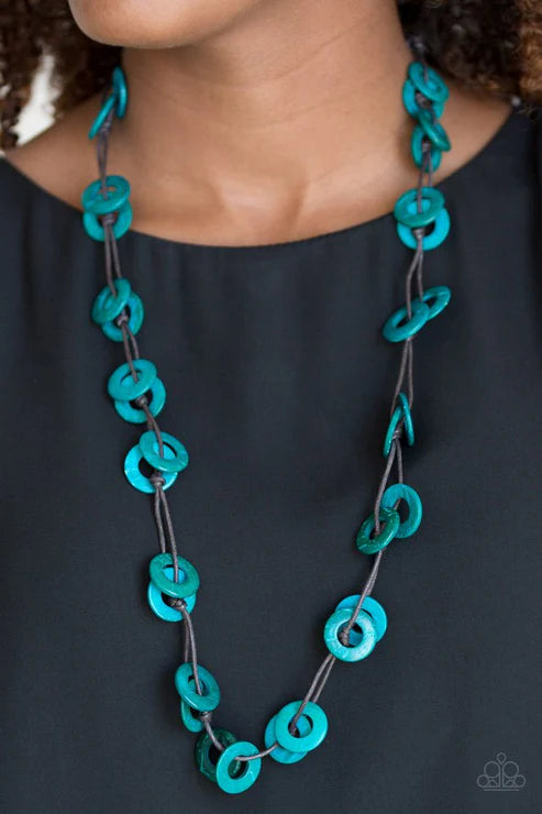 Teal chain necklace on a person wearing a black top