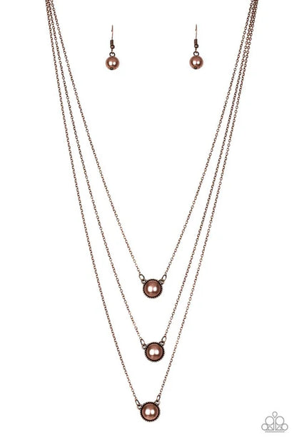 Necklace and earrings set with pink pearls on a white background
