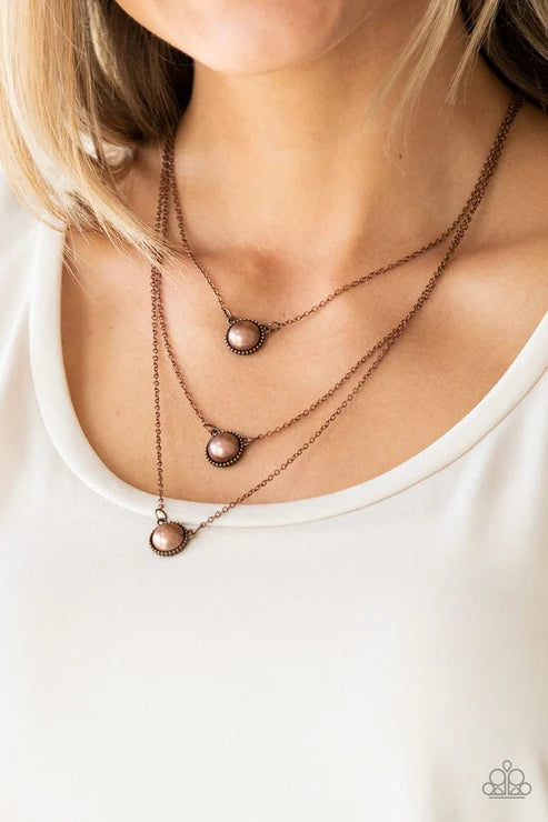 Necklace with three pendant drops on a white background