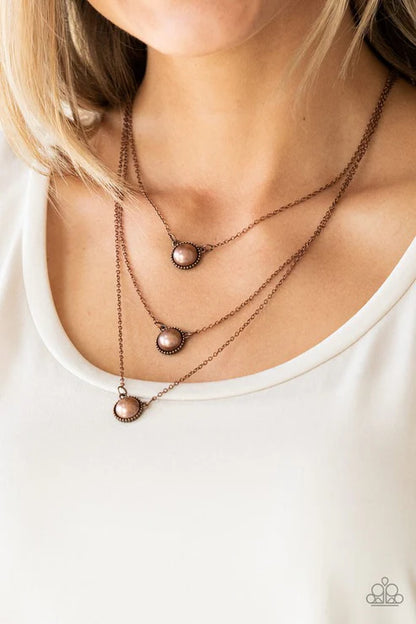 Necklace with three pendant drops on a white background