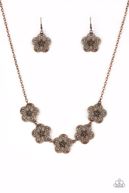 Jewelry set with floral-patterned necklace and earrings on a white background