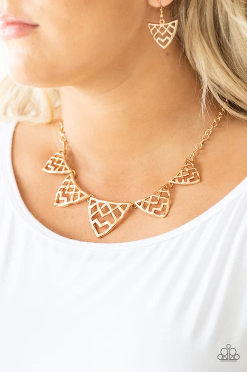 Gold necklace and earrings on a white background