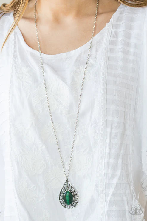 Necklace with a green pendant on a white blouse