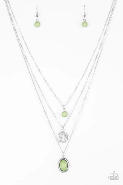 Necklace set with green pendant and matching earrings on a white background