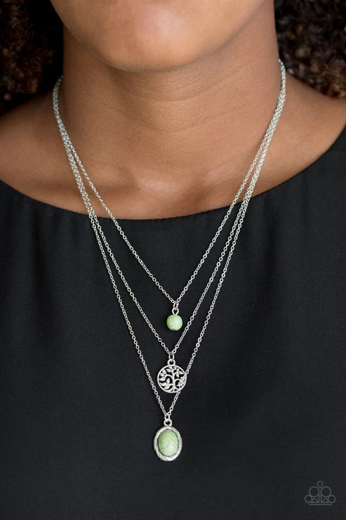Necklace with green pendants on a black background