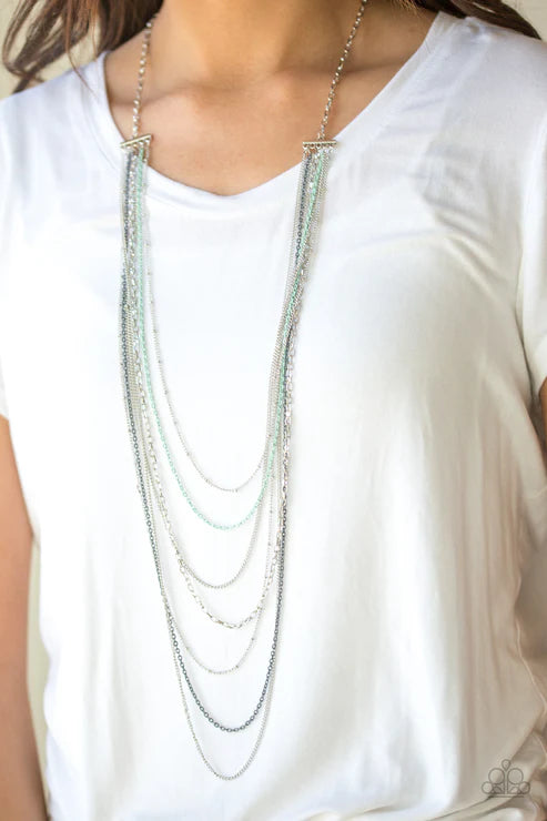 Necklace with multiple strands on a white shirt