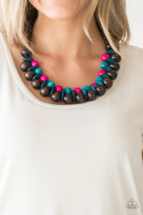 Necklace with multicolored beads worn by a person on a white background