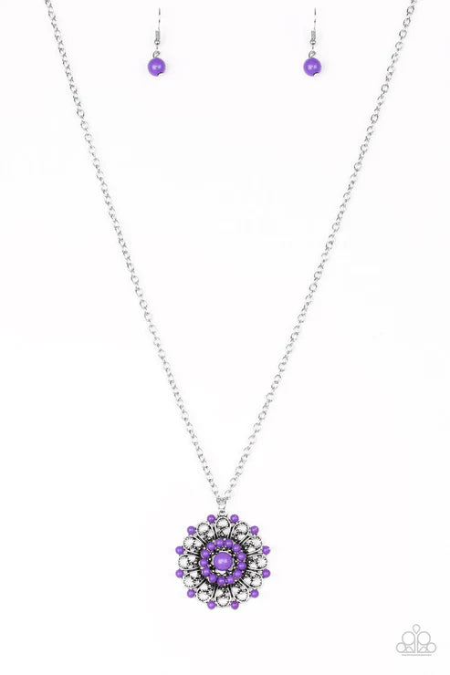 Necklace with purple pendant and matching earrings on a white background