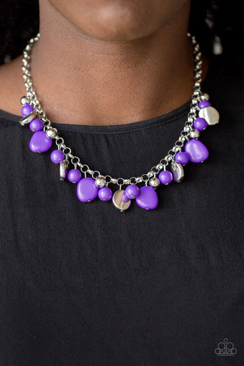 Necklace with purple beads and silver accents on a black background