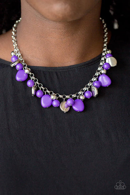 Necklace with purple beads and silver accents on a black background