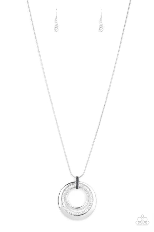 Silver necklace with a circular pendant on a white background