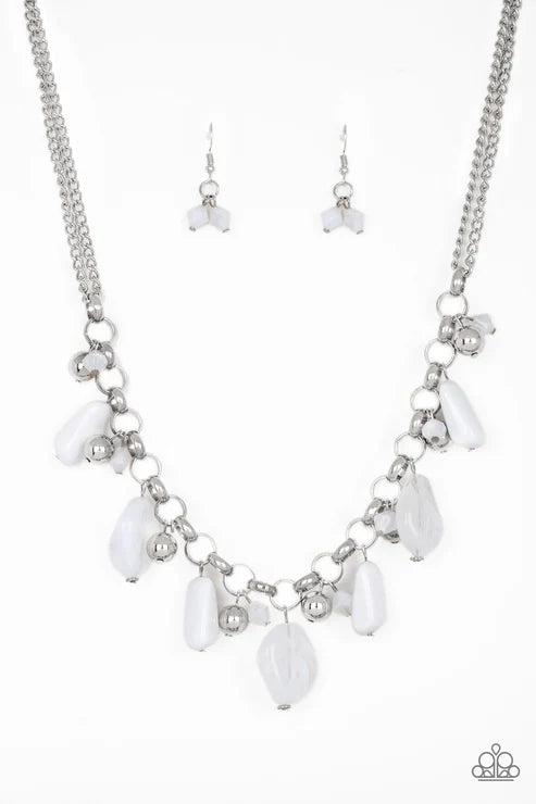Necklace and earrings set with white teardrop-shaped beads on a silver chain against a white background.