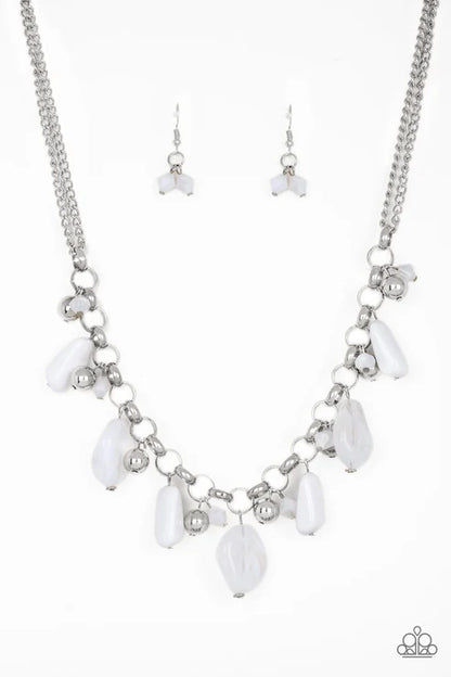 Necklace and earrings set with white teardrop-shaped beads on a silver chain against a white background.