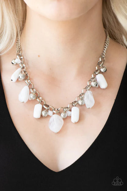 Necklace with white stones and silver chain on a black background