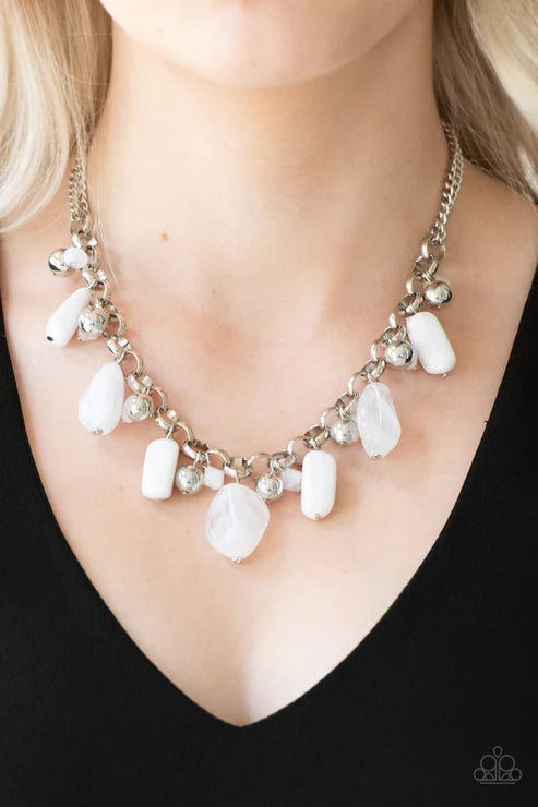 Necklace with white stones and silver chain on a black background