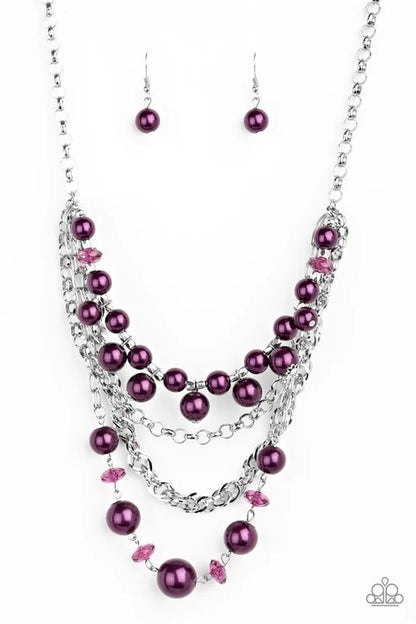 Jewelry set with purple beads and silver chain on a white background