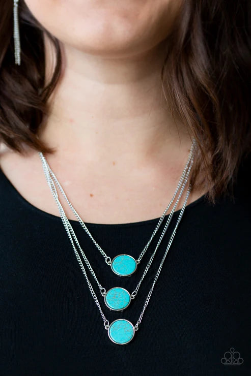 Necklace with turquoise circular pendants on a black background