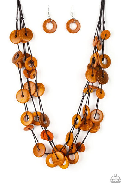Necklace and earrings with orange circular beads on a white background