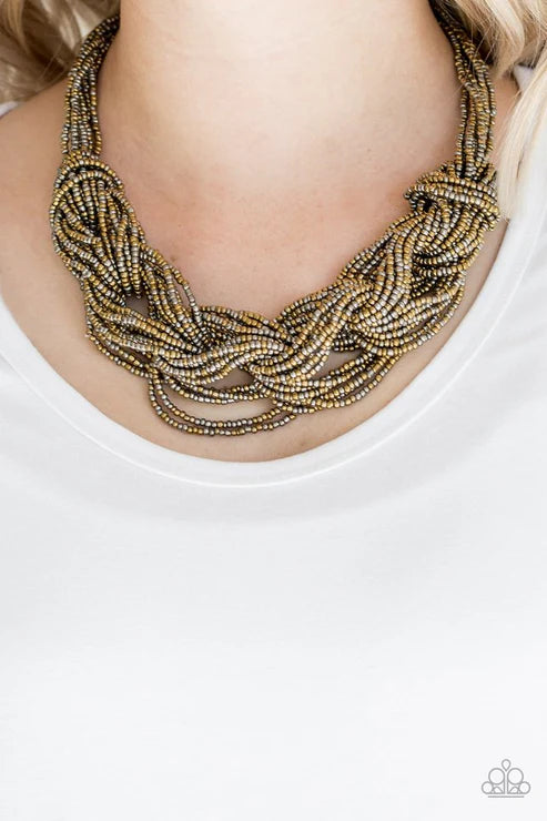 Necklace with braided design worn by a person on a white background