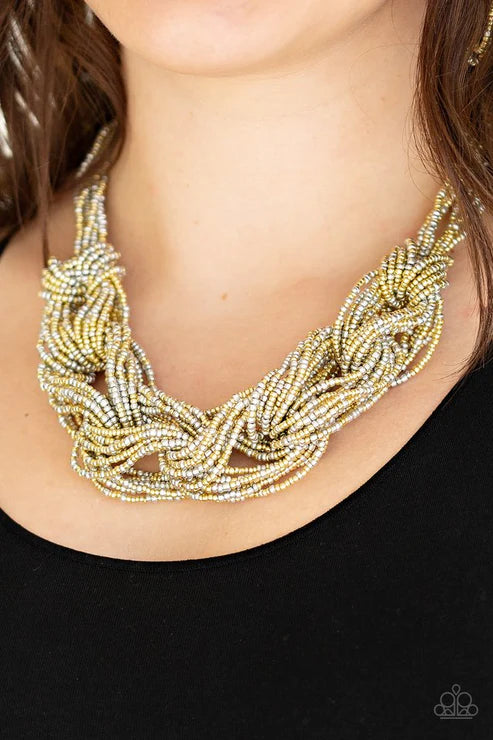 Necklace with braided design worn by a person against a black background
