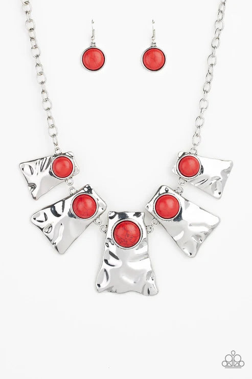 Silver necklace with red stones on a white background