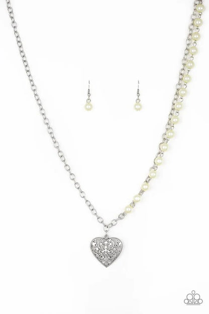 Pearl necklace with silver heart pendant and matching earrings on a white background